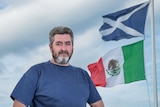 David Milne stands next to the Mexican flag he erected near Donald Trump's golf course in Scotland