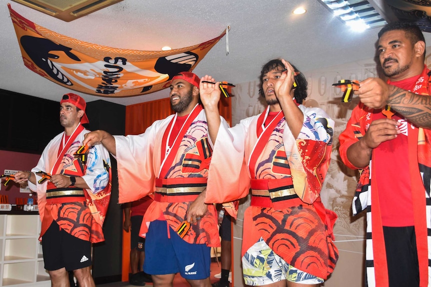 Male rugby union players take part in a Japanese dance ahead of the Rugby World Cup.