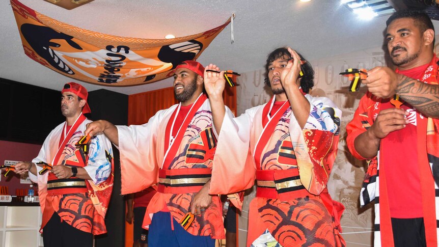 Male rugby union players take part in a Japanese dance ahead of the Rugby World Cup.