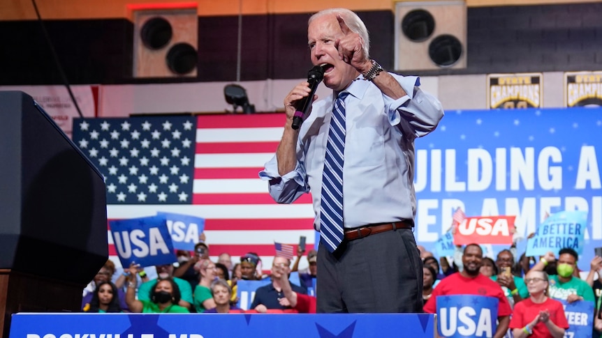 Joe Biden speaking animatedly on stage. 