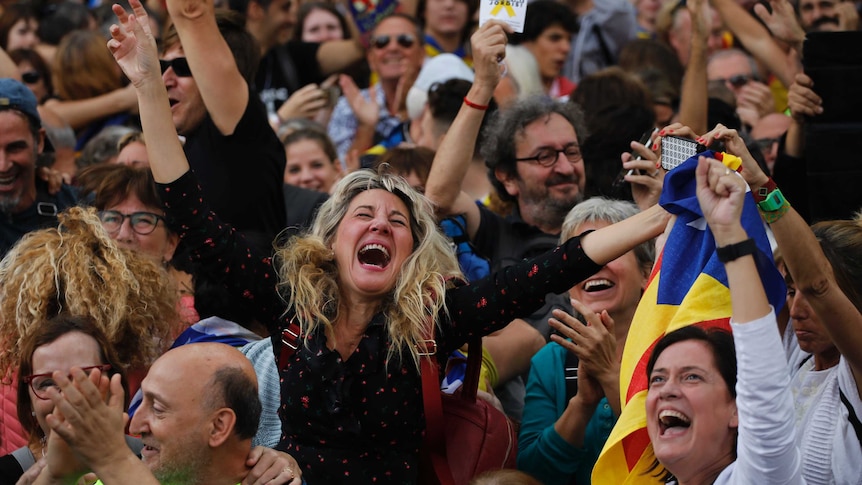 Protesters scream and clap and cheer as the Catalan parliament declares independence.