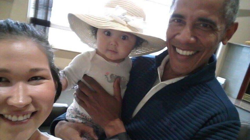 Barack Obama holds Jolene Jackinsky's 6-month-old baby.