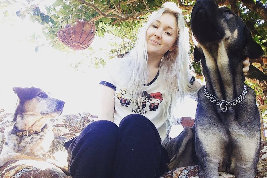 Toyah Cordingley sits with her dogs.