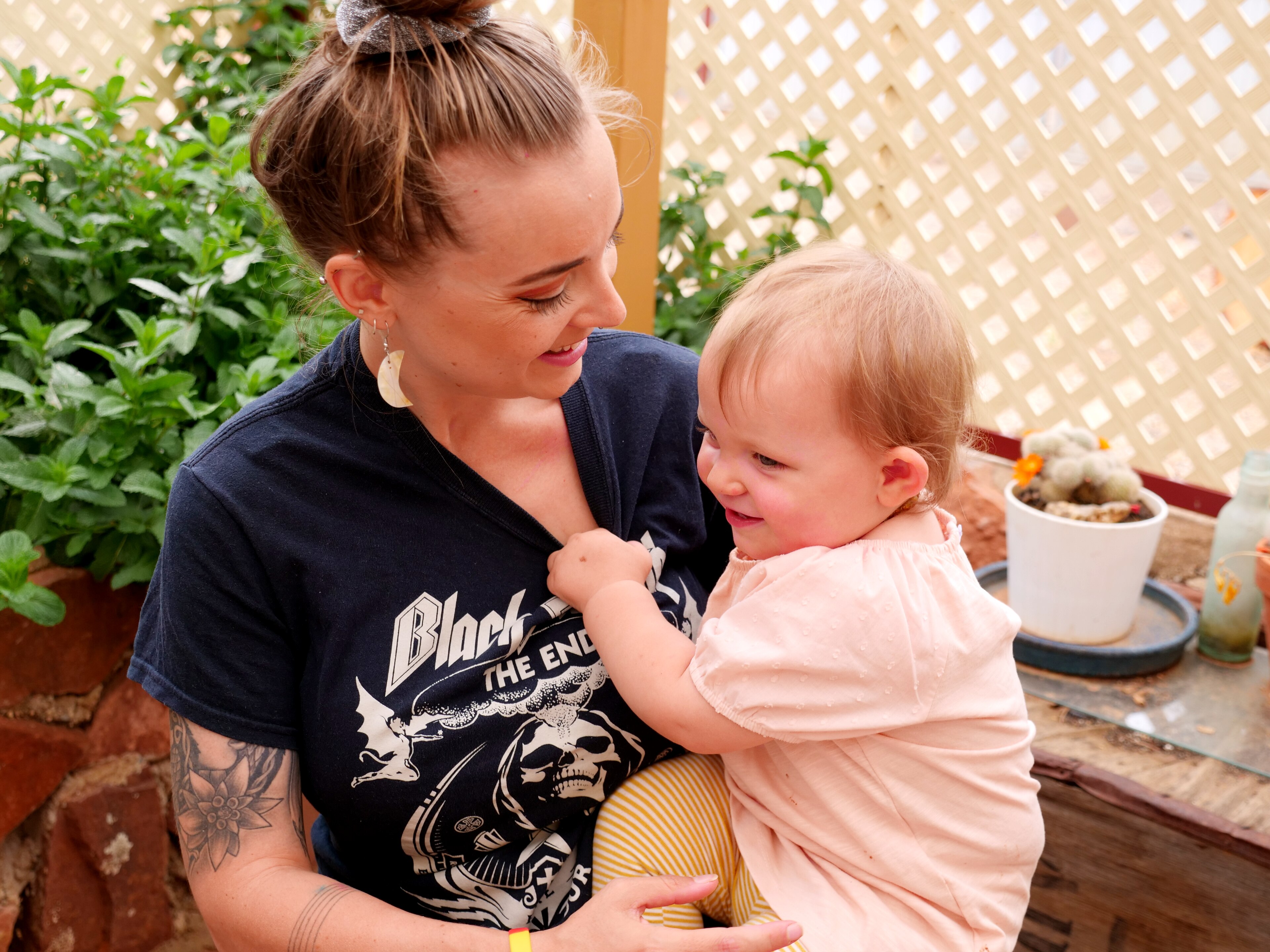 a woman smiling holding a smiling child