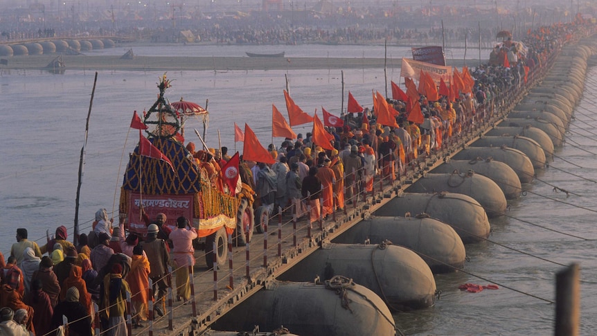 Pilgrims crossing a bridge on the Ganges during the Kumbh Mela festival.