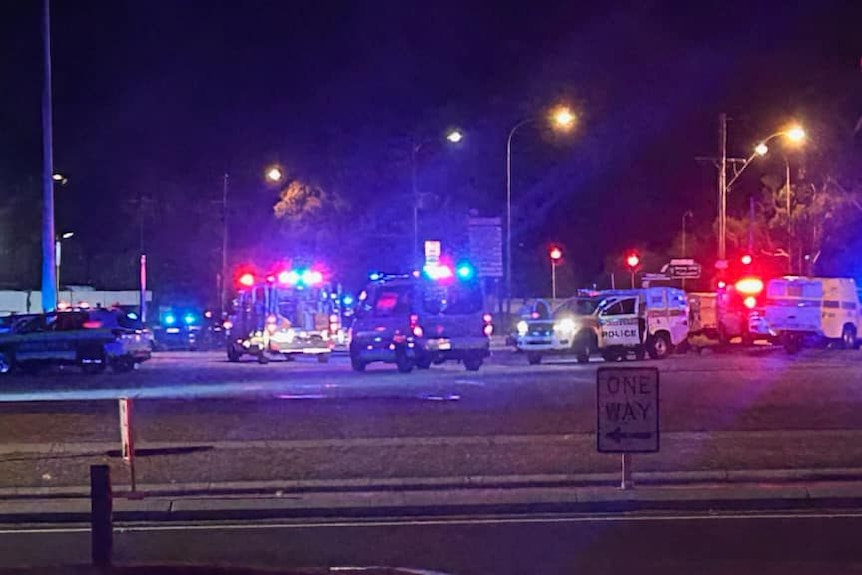 Emergency service vehicles in an empty car park.