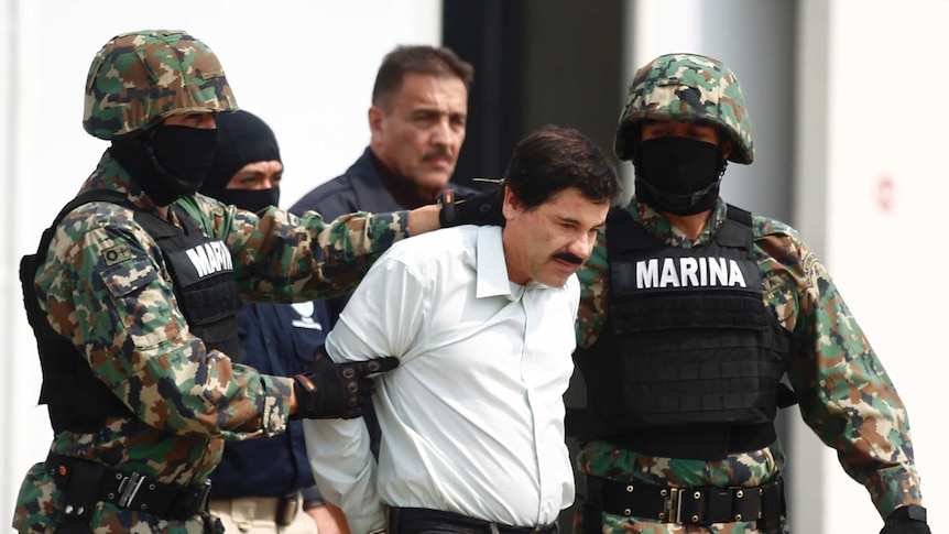 Joaquin Guzman, known as 'Shorty' or 'El Chapo', is escorted by soldiers at the Navy's airstrip in Mexico City.