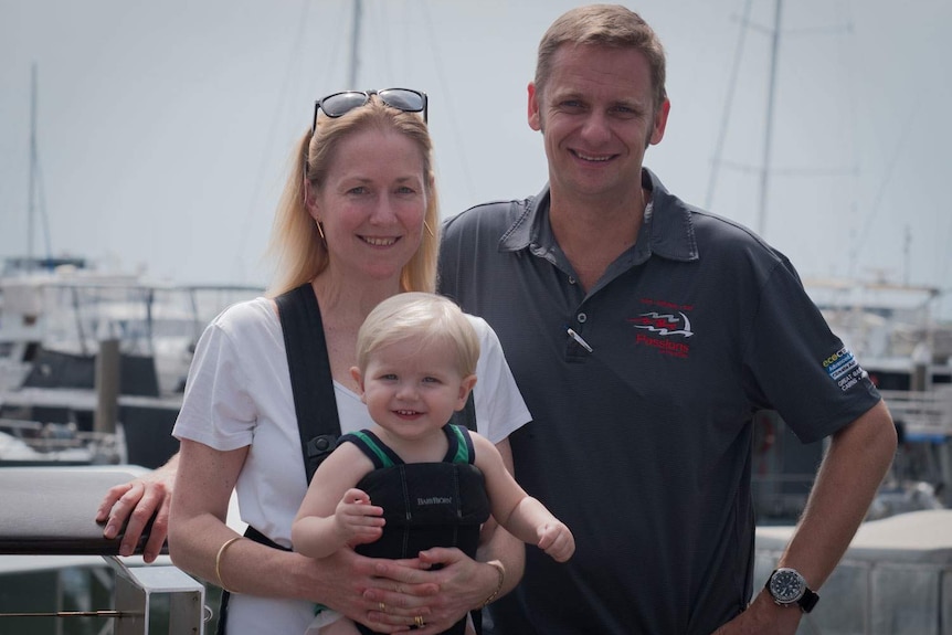 Scott Garden, his wife Karen and their son William stand at a boat marina in Cairns.