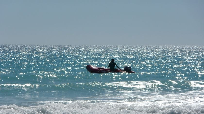 A man using a rubber boat off Broome's Cable Beach.