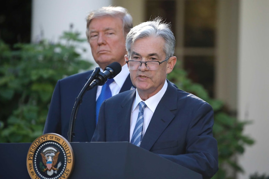 File photo of Federal Reserve chair Jerome Powell giving a speech, with Donald Trump standing behind him, on November 2, 2017.