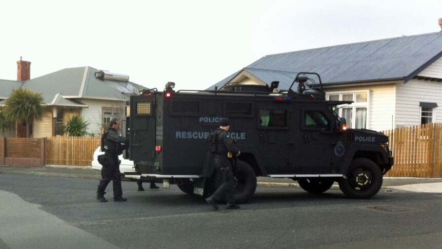 Tasmania police outside the BearCat armoured truck in New Town during a drug raid.