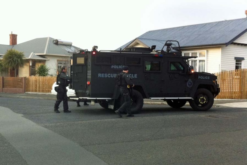 Tasmania police outside the BearCat armoured truck in New Town during a drug raid.
