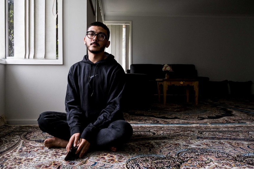 Ali Aqa Ashraf sitting in living room.