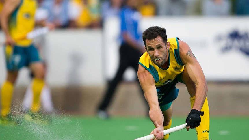 Mark Knowles runs towards the ball during a game of hockey.