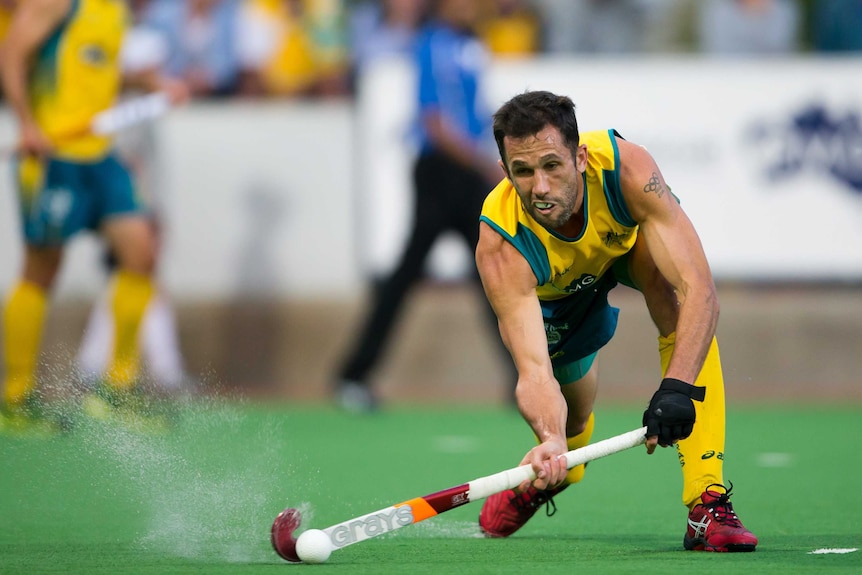 Mark Knowles runs towards the ball during a game of hockey.