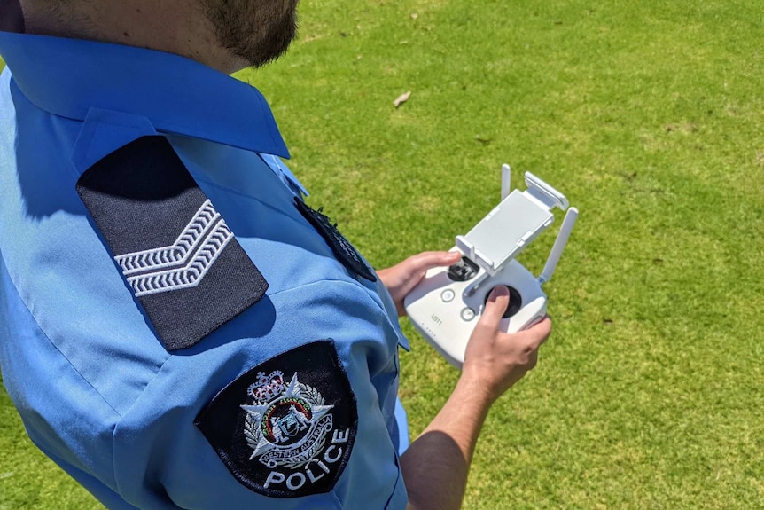 A West Australian Police officer holding a drone controller