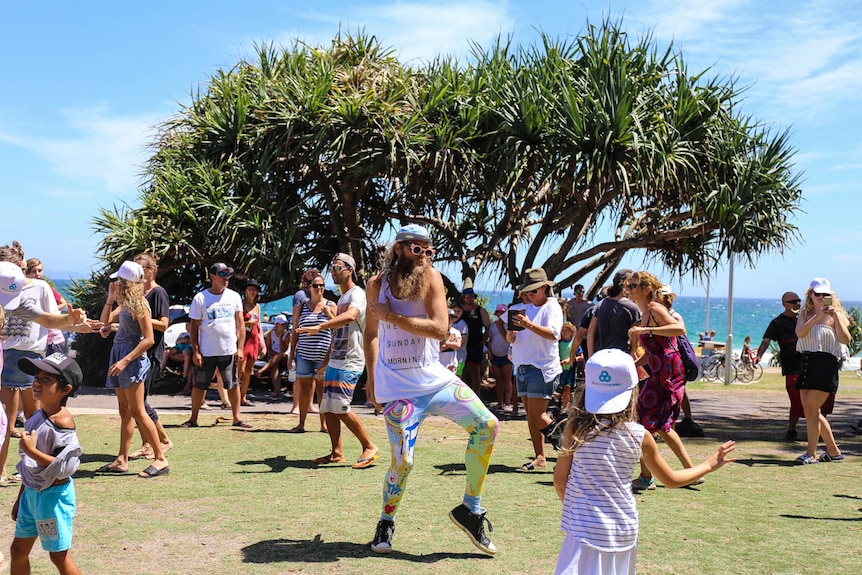 Tommy Franklin dancing in a park at Byron Bay