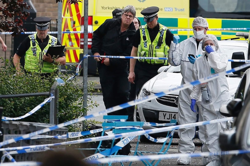 Police and forensics attend the crime scene