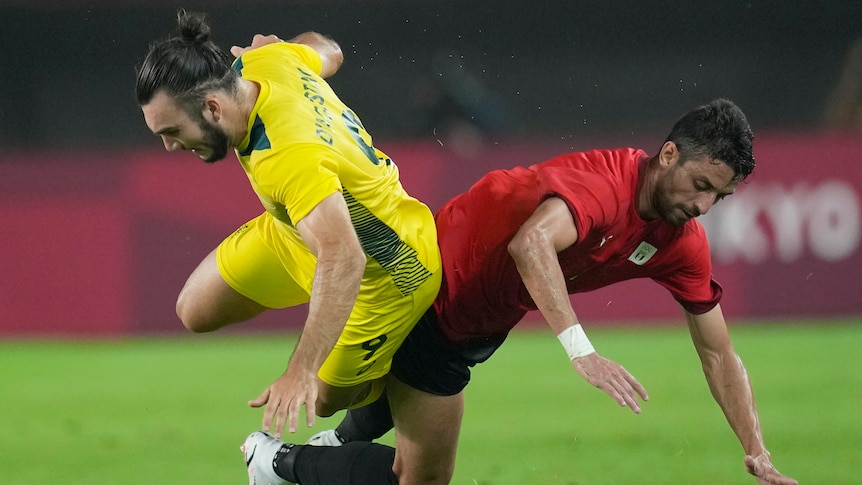 Nicholas D'Agostino falls to ground as he tackles Taher Mohamed