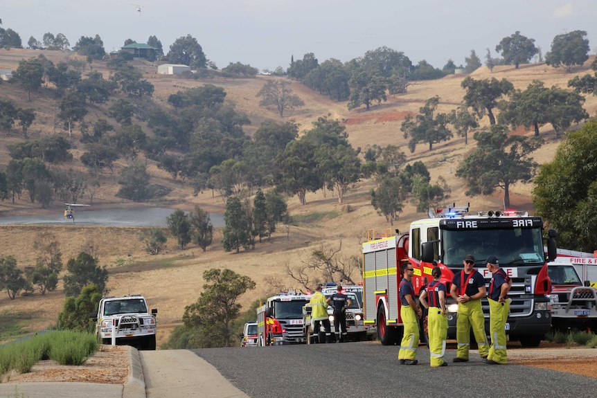 Fire crews and trucks line a road in Bullsbrook