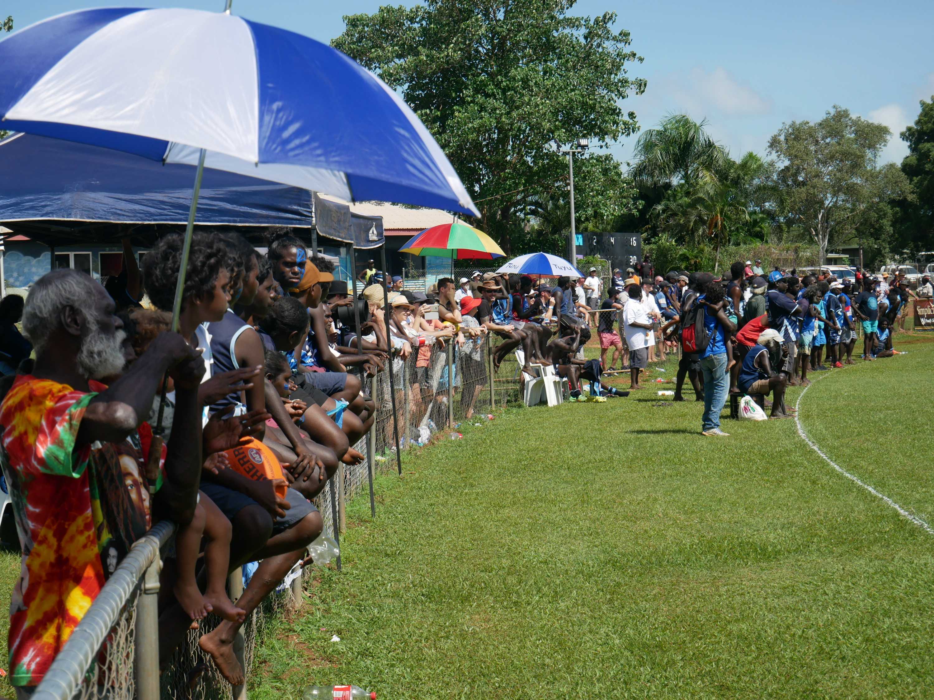 Fans gather along the sidelines to watch the Buffaloes and Dockers grand final.