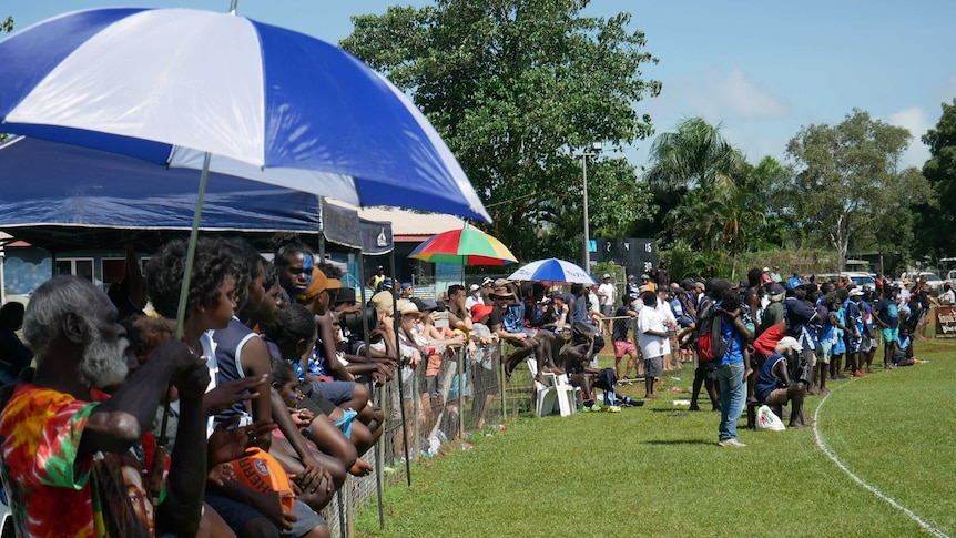 Fans gather along the sidelines to watch the Buffaloes and Dockers grand final.