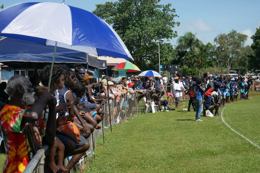 Fans gather along the sidelines to watch the Buffaloes and Dockers grand final.