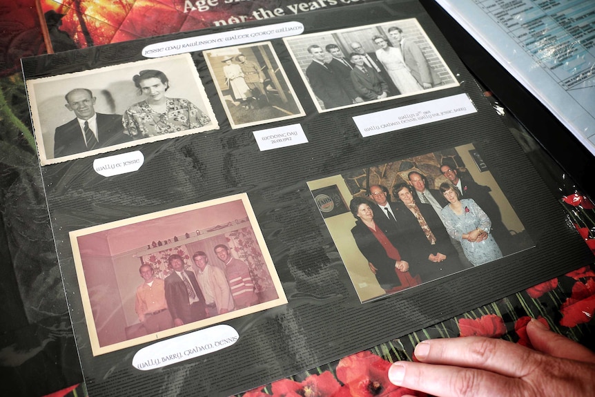 A page of a photo album showing colour and black and white photos of family groups.