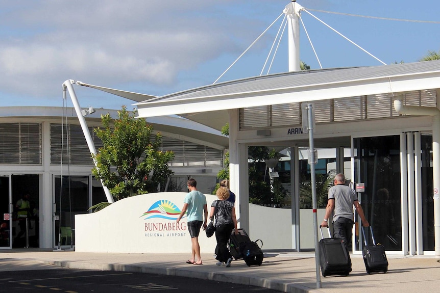 Passengers walk into Bundaberg Airport.