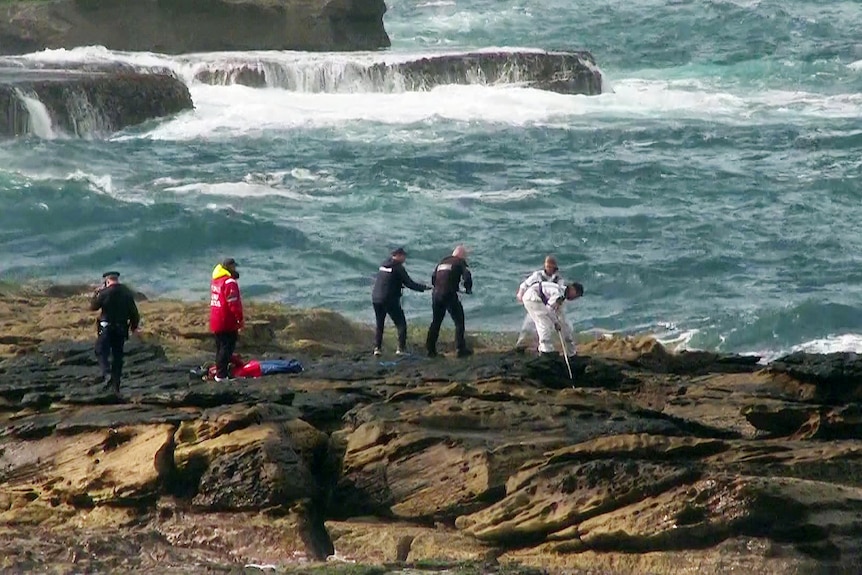 Emergency services search the rocks at  Little Bay Beach after reports of a concern for welfare