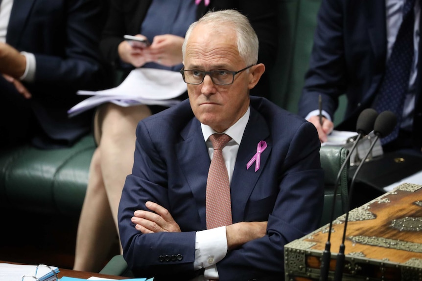 Malcolm Turnbull looks cross as hefolds his arms in the house of representatives.