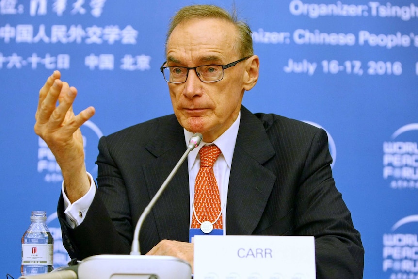 Bob Carr gestures as he speaks during a press conference in China.