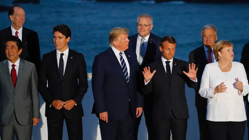 World leaders including US President Donald Trump and Scott Morrison pose for a family photo in Biarritz, France.