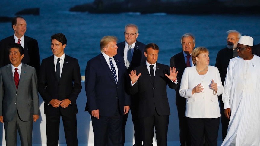 World leaders including US President Donald Trump and Scott Morrison pose for a family photo in Biarritz, France.