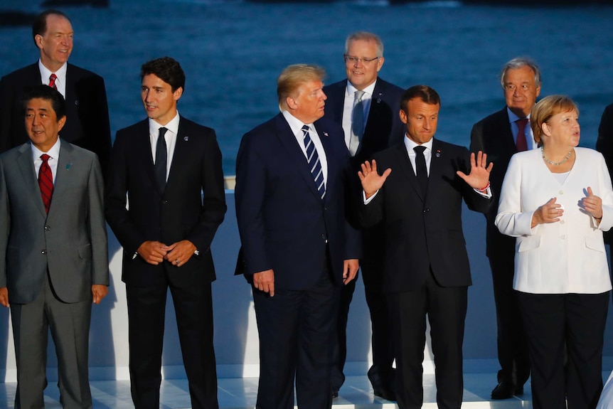 World leaders including US President Donald Trump and Scott Morrison pose for a family photo in Biarritz, France.