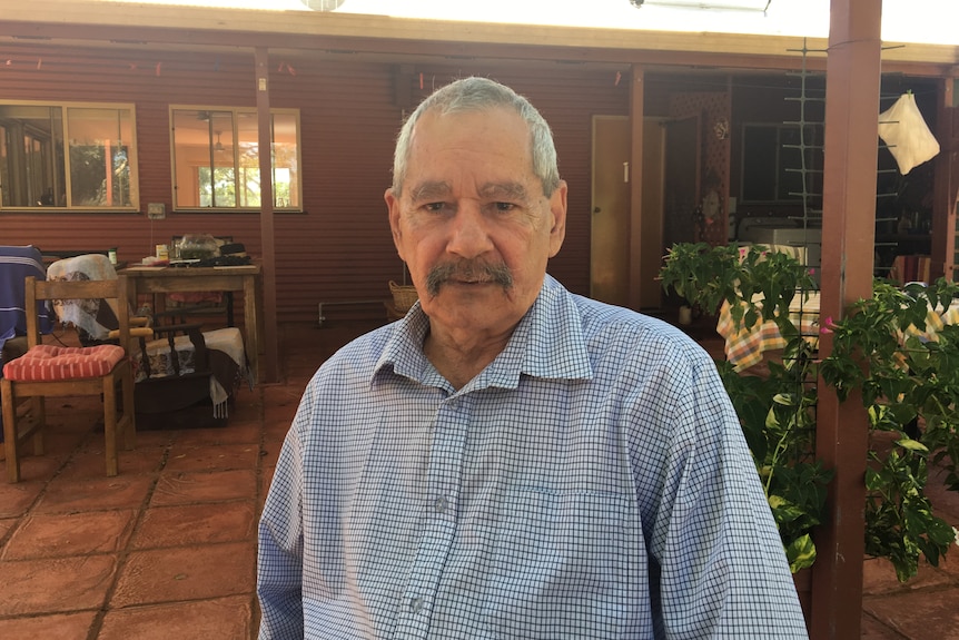 Formerly Barkly MLA Elliot McAdam standing outside a house. 