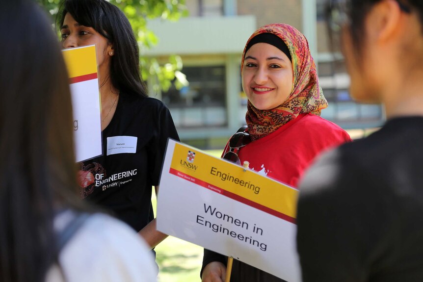 Zeina holding a info day tour sign at the Women in Engineering day