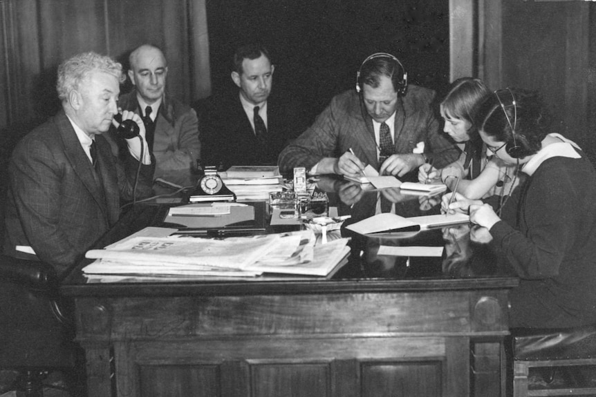 Prime Minister Joseph Lyons and staff receiving details of the king's abdication in the early hours of December 11 1936.