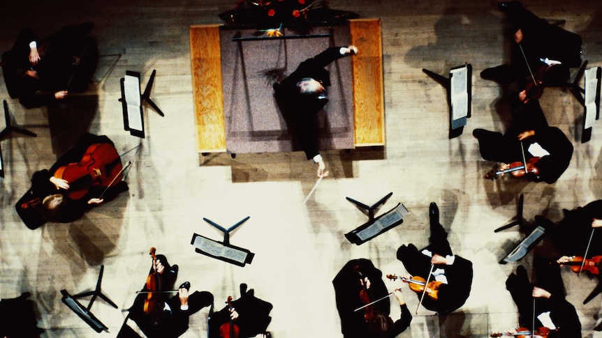 Overhead view of an orchestra conductor