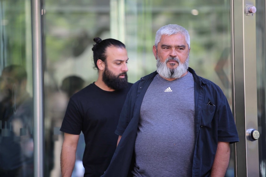 The father of Kaya brothers, Haci Kaya, walks out of court.