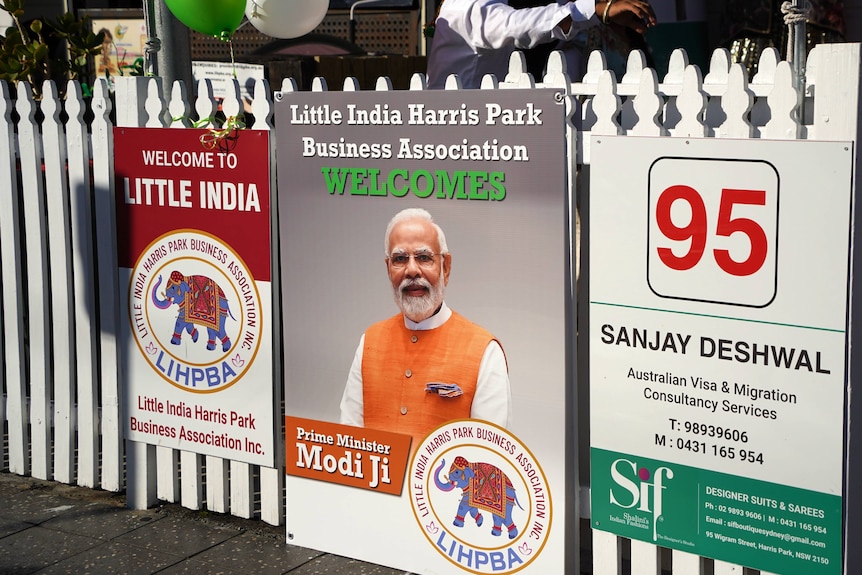 A sign on a fence with a picture of India's Prime Minister Narendra Modi