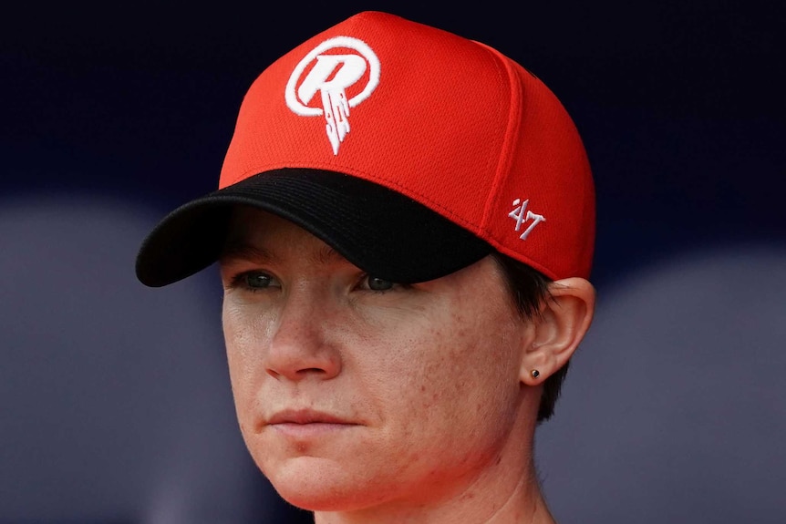 A Melbourne Renegades WBBL player watches a match from the Grandstand.