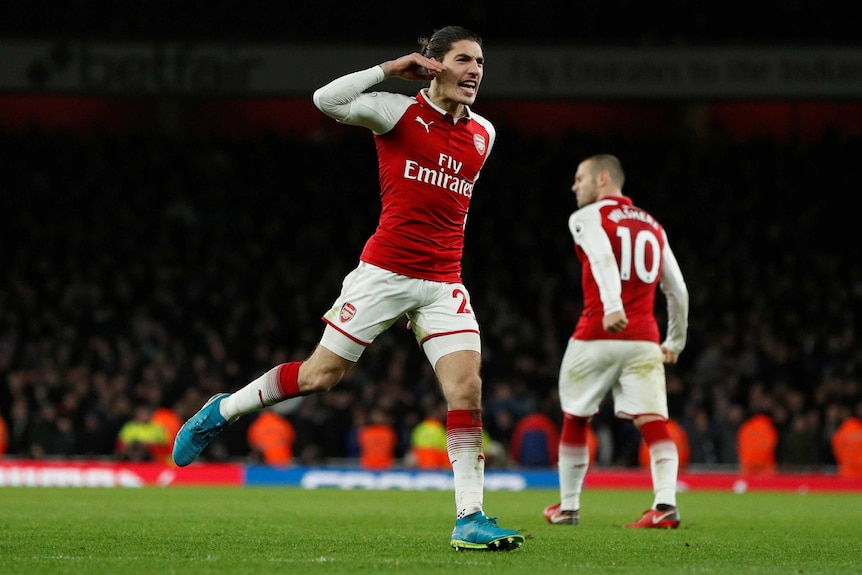 Arsenal's Hector Bellerin salutes as he celebrates scoring a goal against Chelsea.