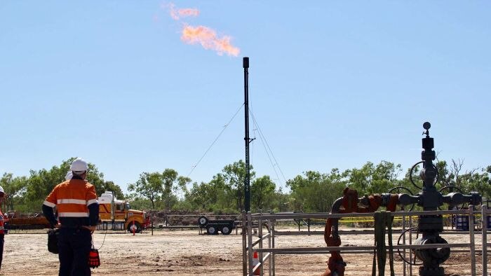 A flame spurts out from a gas well in Amungee.