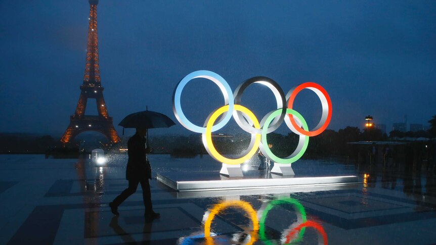 Olympics rings are lit up in front of the Eiffel Tower.