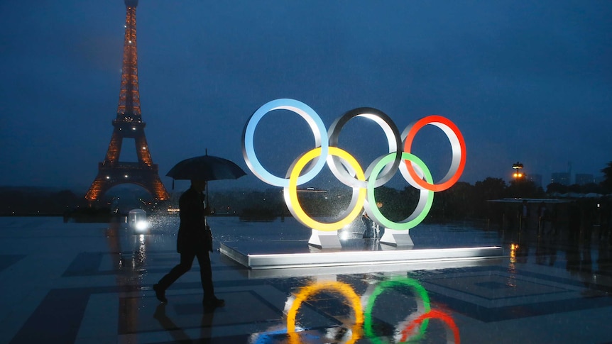 Olympics rings are lit up in front of the Eiffel Tower.