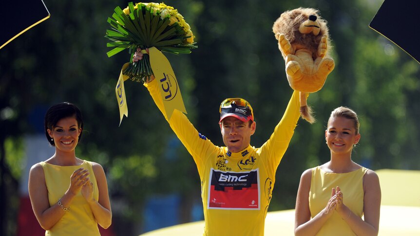 Cadel Evans celebrates on the podium after winning last year's Tour De France in Paris.