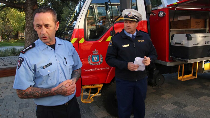 Steven Richardson (l) from the Tasmania Fire Service and Inspector Darren Hopkins from the Tasmania Police