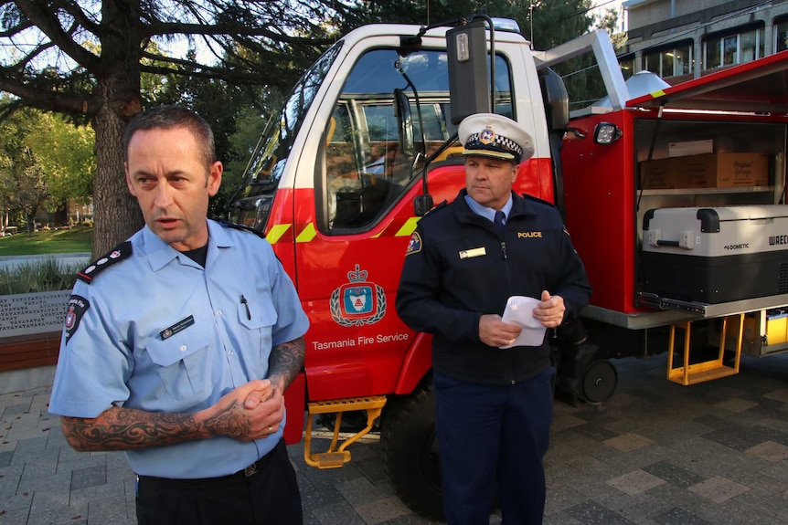 Steven Richardson (l) from the Tasmania Fire Service and Inspector Darren Hopkins from the Tasmania Police