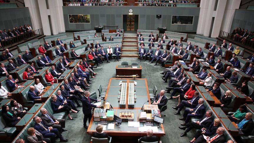 An almost-full Parliament sits watching Bill Shorten's speech